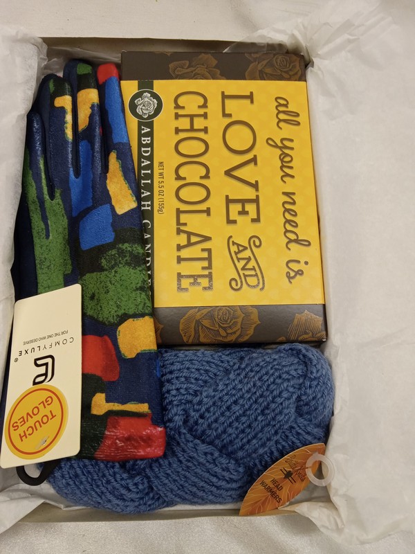 picture of gift box containing a pair of gloves, headwarmer, and a box of chocolates