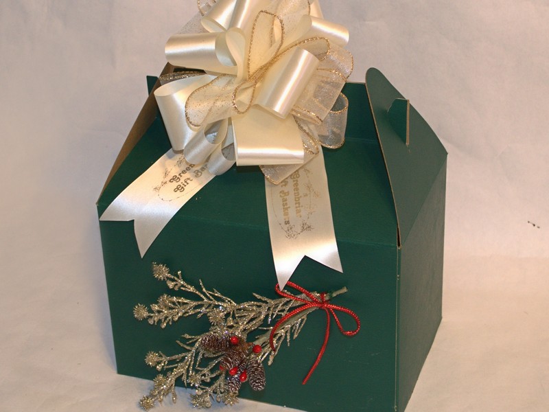 large dark green gable box decorated with Christmas sprig and printed logo ribbon