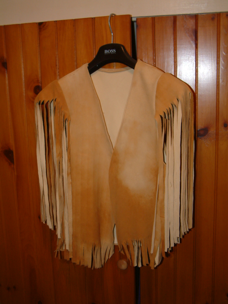 image of handmade doeskin vest on clothes hanger