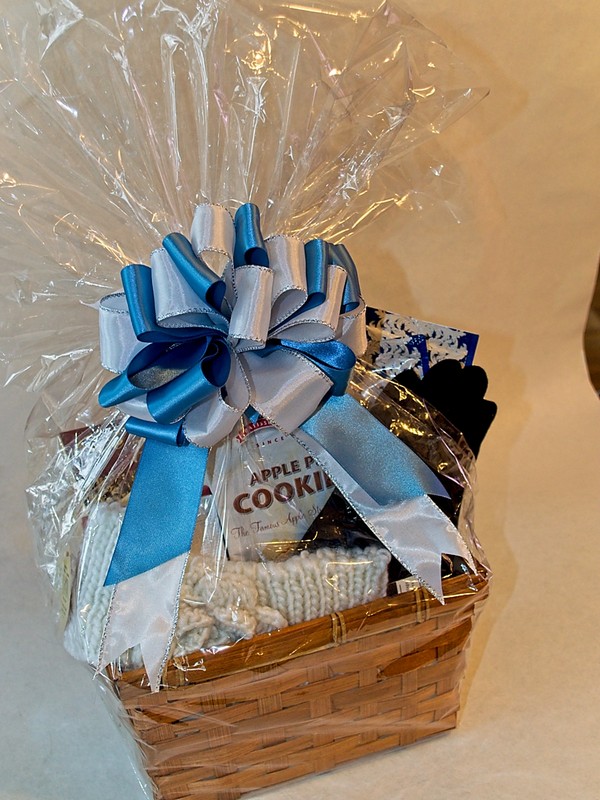 picture of gift basket featuring warm fleece texting gloves, a cute knit headwarmer, and hot chocolate!